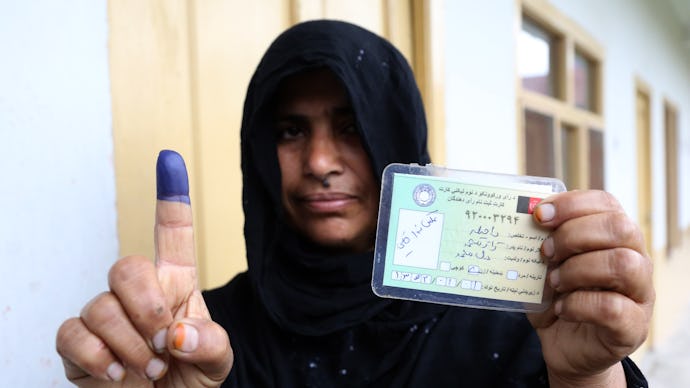 An Afghan woman showing her inked finger after voting in Jalalabad. 