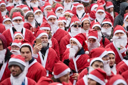 a large group of santas going down the street
