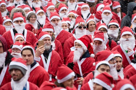 a large group of santas going down the street