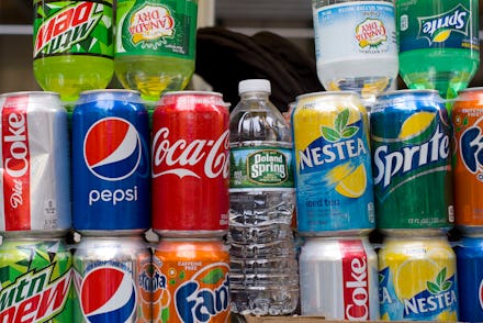 Coke, Pepsi, Fanta, Sprite, and Nestea cans stacked on top of each other