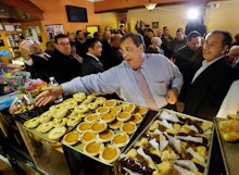 Chris Christie waving to workers at a pastry shop during campaign