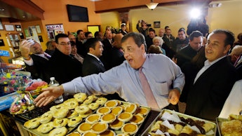 Chris Christie waving to workers at a pastry shop during campaign