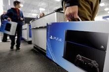 Two men holding PS4 boxing while waiting to buy them at a shop cash register