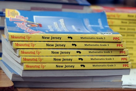 Five blue books for school stacked on top of each other
