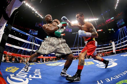 Floyd Mayweather fighting in the ring wearing white shorts