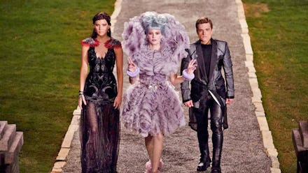 Characters from the hunger games wearing elaborate bold and high fashion looks