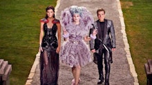 Characters from the hunger games wearing elaborate bold and high fashion looks