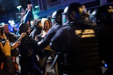 Young people protesting next to policemen