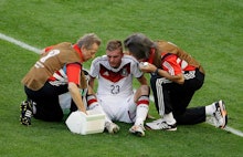 Christoph Kramer being checked out by doctors at the FIFA's doctors after suffering a concussion