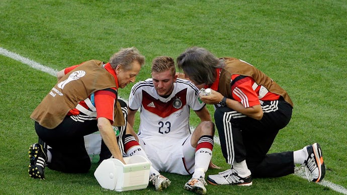 Christoph Kramer being checked out by doctors at the FIFA's doctors after suffering a concussion