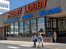 The store front of the hobby lobby with people entering and leaving the store