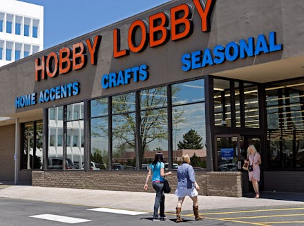 The store front of the hobby lobby with people entering and leaving the store
