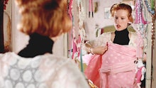 Molly Ringwald holding up a dress to her in the movie Pretty in pink