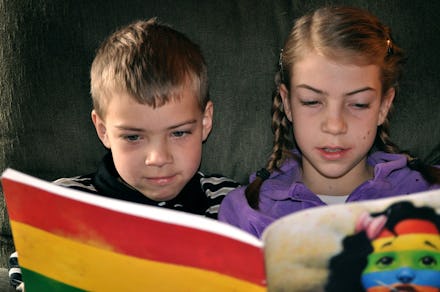 Two kids reading a book together and test how fast they can read