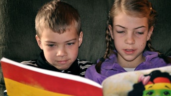 Two kids reading a book together and test how fast they can read