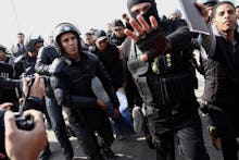 A group of police officers in Egypt's turmoil facing journalists