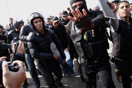 A group of police officers in Egypt's turmoil facing journalists
