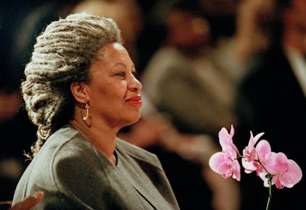 Toni Morrison holding pink flowers