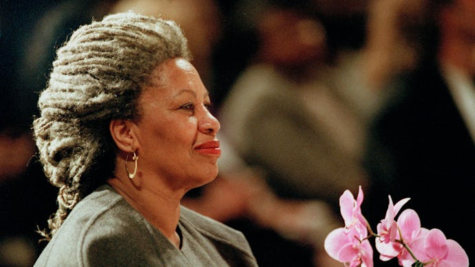Toni Morrison holding pink flowers