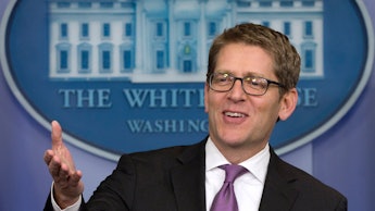 Jay Carney speaking in the white house press room to journalists