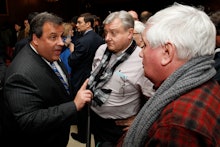 Chris Christie talking with two men