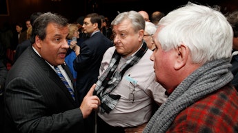 Chris Christie talking with two men