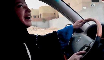 A woman with a hijab driving in a car 