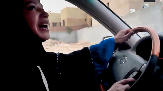 A woman with a hijab driving in a car 