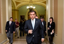 Ted Cruz walking with his staff following him