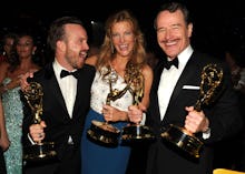 Aaron Paul, Anna Gunn, and Bryan Cranston posing for a photo