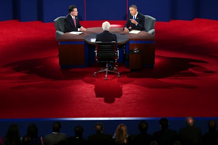 Mitt Romney sitting with two men in a TV show and talking about Obamacare