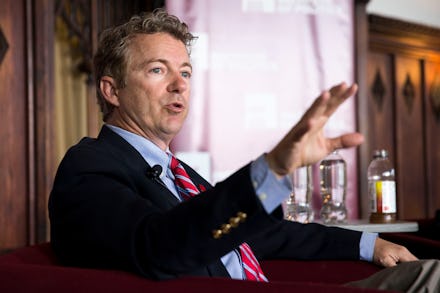 Senator Rand Paul in a suit and tie sitting in a chair giving an interview