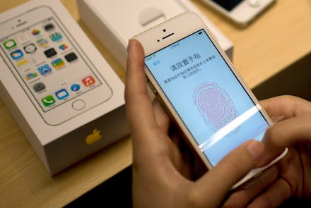 Person setting up the fingerprint ID on an iPhone in China