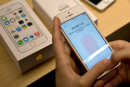 Person setting up the fingerprint ID on an iPhone in China