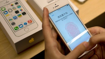 Person setting up the fingerprint ID on an iPhone in China