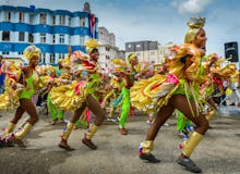 Cuban dancers in colorful costumes dancing on the streets