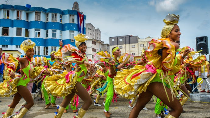 Cuban dancers in colorful costumes dancing on the streets
