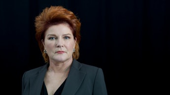 A portrait of Kate Mulgrew in in a black suit from 'Orange is the New Black'