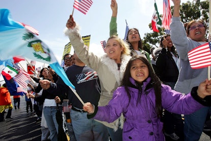 Latinos at a protest holding the flags of their countries