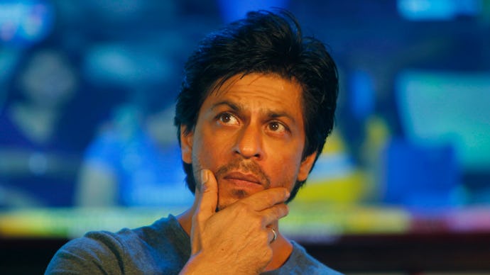 Shah Rukh Khan, famous Bollywood actor, posing with his hand on his chin, looking off into the dista...