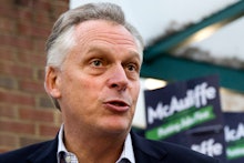 Terry McAuliffe in a white shirt, and a black blazer being interviewed