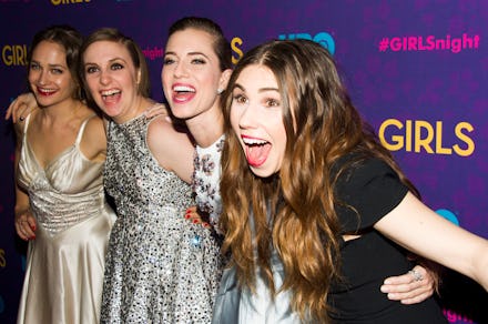 Four girls from HBO series Girls hugging each other at a series screening, with wide smiles on their...