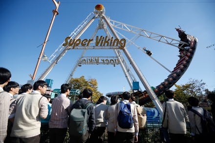 People in an amusement park waiting in line for a roller coaster ride at the Korean DMZ