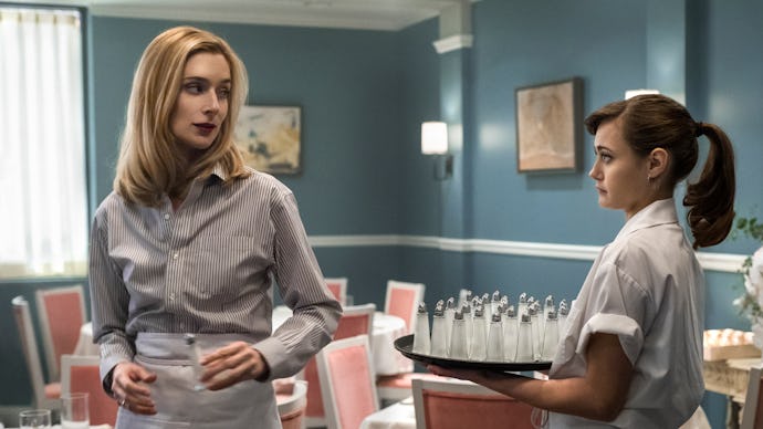 Caitlin FitzGerald standing in a restaurant playing a waitress on tv