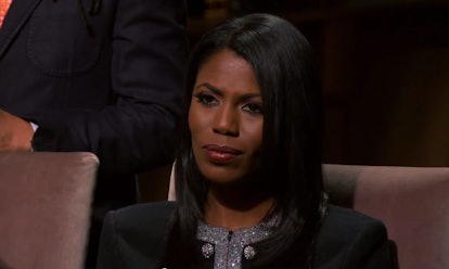 An African-American woman frowns during a TV show