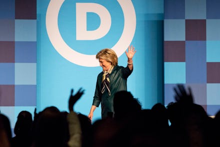 Hillary Clinton waving at the audience after finishing her speech at a political rally