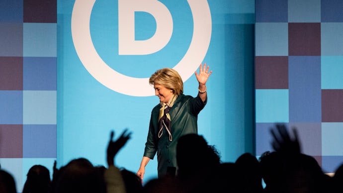 Hillary Clinton waving at the audience after finishing her speech at a political rally