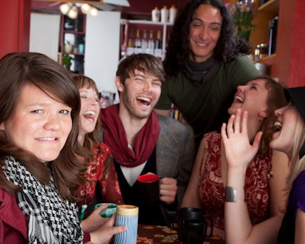 A group of young people sitting together, smiling and laughing about the 5 basic financial words