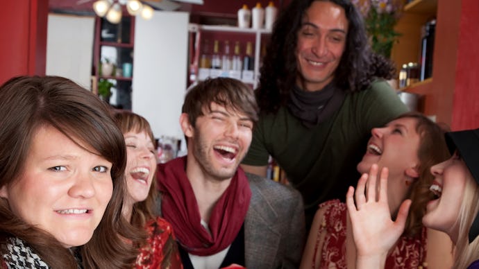 A group of young people sitting together, smiling and laughing about the 5 basic financial words