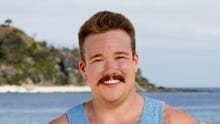 Zeke Smith smiling on the set of survivor